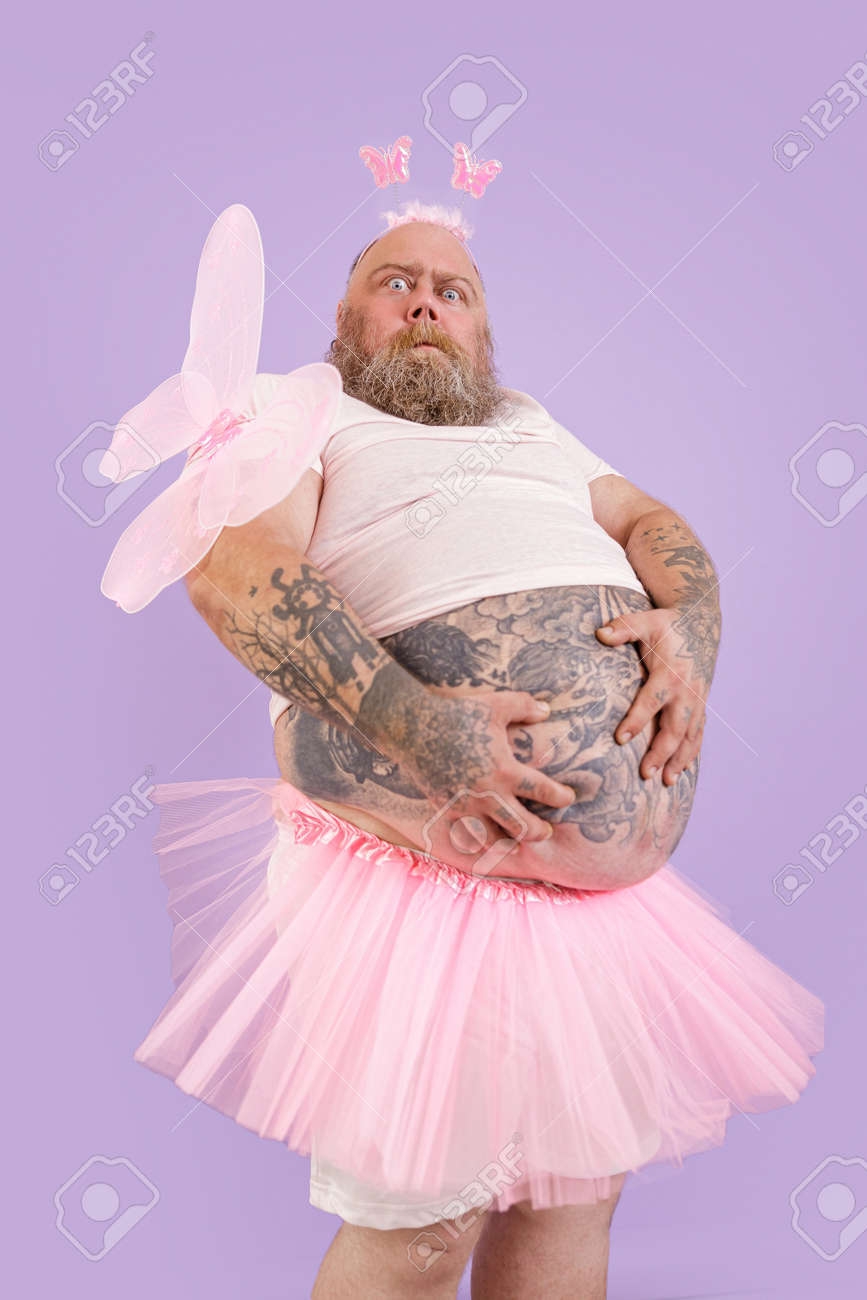 172956672-surprised-plump-male-person-in-fairy-costume-holds-large-tummy-on-purple-background.jpg.c06135192226eda0cdf4a9451d8f9fef.jpg